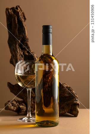 White wine and old snag on a beige background. White wine and old snag on a beige background. 131450906