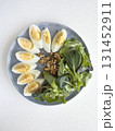 Boiled Eggs, Walnuts, and Fresh Green Salad on plate 131452911