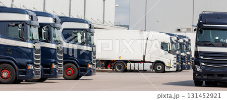 Modern blue cargo truck delivery van parked logistics warehouse center complex building exterior bay. Semi-trailer lorry unload goods distribution blue sky. Cargo storage facility industry building Modern blue cargo truck delivery van parked logistics warehouse center complex building exterior bay. Semi-trailer lorry unload goods distribution blue sky. Cargo storage facility industry building 131452921