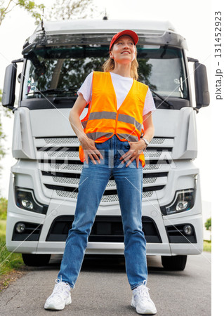 Portrait young adult happy smiling woman heavy truck driver modern cargo vehicle cabin background. Female person girl professional job career working driving freight engine lorry. Logistics industry Portrait young adult happy smiling woman heavy truck driver modern cargo vehicle cabin background. Female person girl professional job career working driving freight engine lorry. Logistics industry 131452923