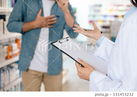 Unrecognizable woman pharmacist recording information during client consultation Unrecognizable woman pharmacist recording information during client consultation 131453232