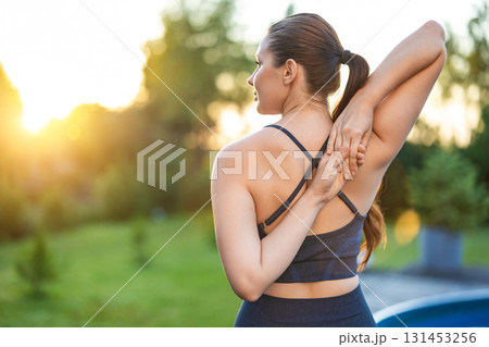 Waist up of a woman stretching her arms while doing yoga 131453256