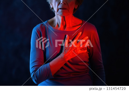 Senior woman experiencing chest pain and heart attack Senior woman experiencing chest pain and heart attack 131454720