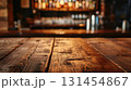 Dark cafe or bar mock up, wooden table close up in the front, blurred bokeh interior background in the back. 131454867