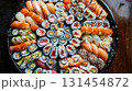 Overhead view of a vibrant sushi platter arranged, showcasing an array of colorful rolls and nigiri adorned with fresh fish, avocado, and colorful ingredients 131454872