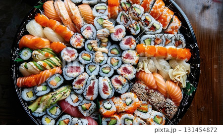 Overhead view of a vibrant sushi platter arranged, showcasing an array of colorful rolls and nigiri adorned with fresh fish, avocado, and colorful ingredients Overhead view of a vibrant sushi platter arranged, showcasing an array of colorful rolls and nigiri adorned with fresh fish, avocado, and colorful ingredients 131454872