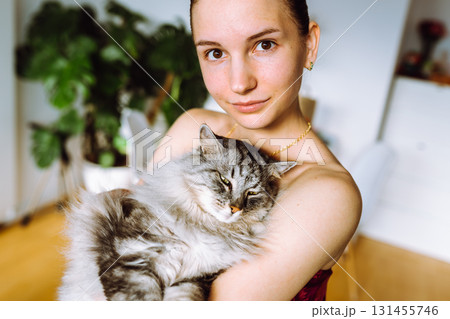 Portrait young woman with pet cat Portrait young woman with pet cat 131455746