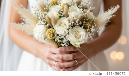 A hyper-realistic, high-detail close-up photograph of a bride's hands gently holding a gorgeous wedding bouquet A hyper-realistic, high-detail close-up photograph of a bride's hands gently holding a gorgeous wedding bouquet 131456071