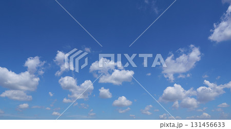 Beautiful white clouds drifting across a vibrant blue sky 131456633