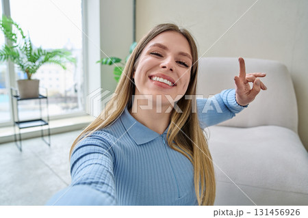 Selfie portrait happy beautiful young woman in home interior Selfie portrait happy beautiful young woman in home interior 131456926