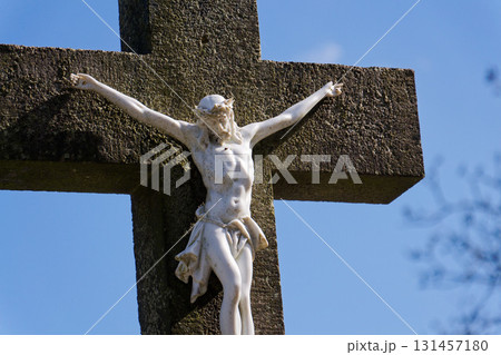 Beautiful Jesus Christ on crucifix, cemetery on a sunny day, spring, Easter, new life and religion concept Beautiful Jesus Christ on crucifix, cemetery on a sunny day, spring, Easter, new life and religion concept 131457180