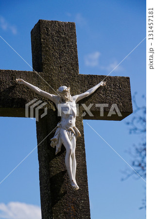 Beautiful Jesus Christ on crucifix, cemetery on a sunny day, spring, Easter, new life and religion concept Beautiful Jesus Christ on crucifix, cemetery on a sunny day, spring, Easter, new life and religion concept 131457181