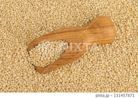 white quinoa seeds in wooden scoop as a background. Top view. Flat lay 131457871