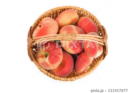 chinese flat donut peaches in a wicker basket isolated on white background. Top view. Flat lay chinese flat donut peaches in a wicker basket isolated on white background. Top view. Flat lay 131457877