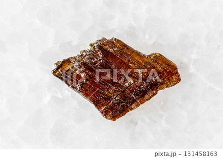 sample of rough rutile mineral on white marble sample of rough rutile mineral on white marble 131458163