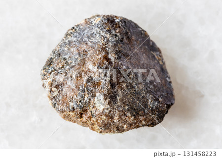 sample of raw brown titanite mineral on white 131458223