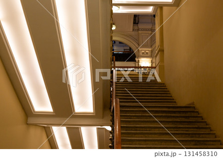 Beautifully lit staircase with modern lighting accents, showcasing elegance and architectural design of space. The soft glow highlights the staircase details, creating serene atmosphere 131458310