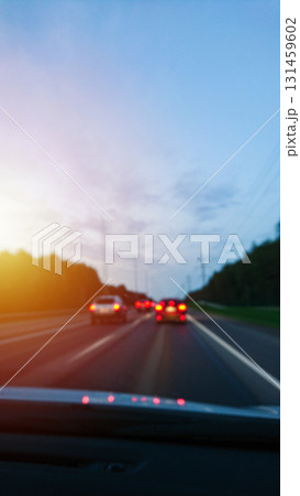 Evening highway scene with fast traffic overtaking on road. Risky driving on wet asphalt 131459602