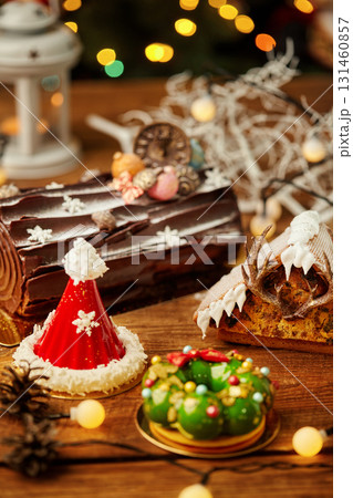 Christmas cakes displayed on wooden table with festive decorations Christmas cakes displayed on wooden table with festive decorations 131460857