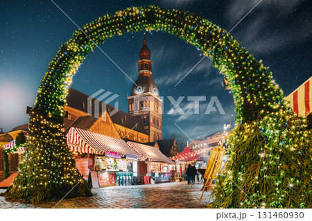 Riga, Latvia. Traditional Christmas Market On Dome Square With Cathedral. Famous Landmark In Winter Evening Night In Festive Illuminations Lighting 131460930