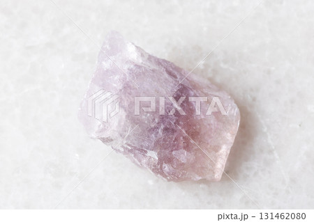 sample of uncut purple fluorite mineral on white sample of uncut purple fluorite mineral on white 131462080