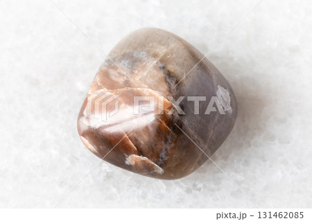 sample of tumbled nepheline rock on white marble sample of tumbled nepheline rock on white marble 131462085