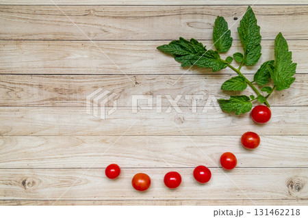 cherry tomatoes on wooden table background 131462218