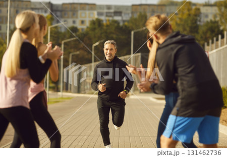 Group Of A People Engaged In Jogging Session In City Park Group Of A People Engaged In Jogging Session In City Park 131462736