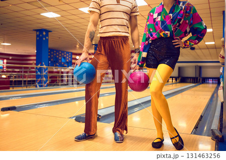 Man and woman holding bowling balls in vibrant retro style Man and woman holding bowling balls in vibrant retro style 131463256