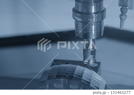 Close up  the CNC milling machine rough cut the mold parts in the light blue scene. 131463277