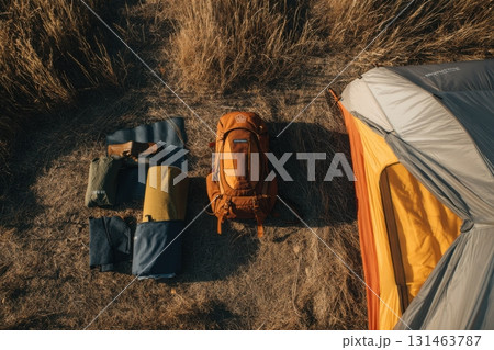 Top view of minimal campsite with tent mat and backpack travel setup for outdoor adventure 131463787
