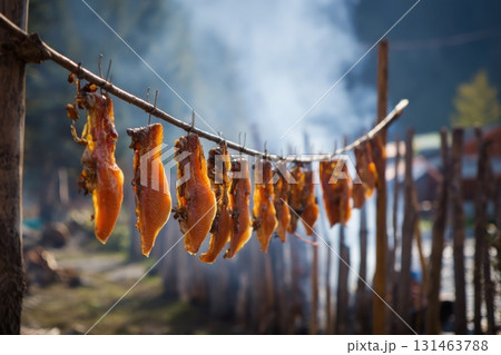 Traditional northern indigenous candied salmon hanging to dry 131463788