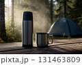 Morning scene with thermos and mug on table 131463809