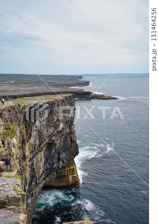 Dramatic view of rugged cliffs meeting the vast ocean in the beautiful landscape of Ireland. 131464256