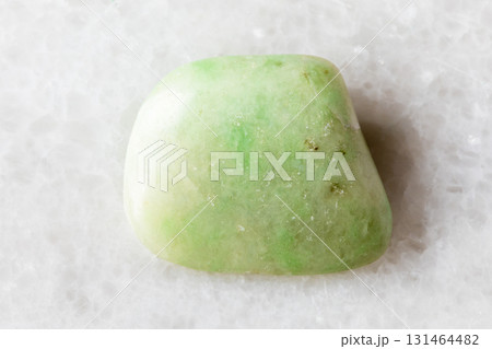 sample of polished rodingite rock on white marble 131464482