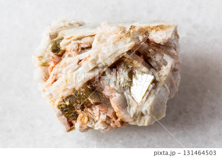 sample of raw albite rock with muscovite on white sample of raw albite rock with muscovite on white 131464503