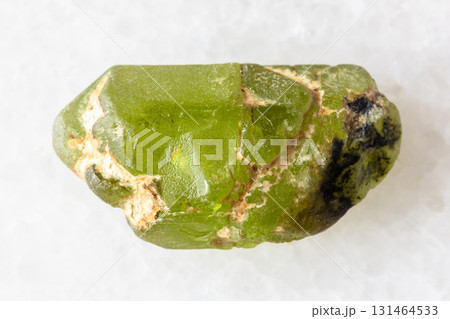 sample of rough peridod crystal on white marble sample of rough peridod crystal on white marble 131464533