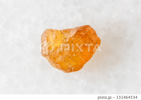 unpolished hessonite grossular crystal on white unpolished hessonite grossular crystal on white 131464534