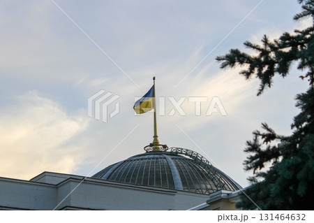 Ukrainian flag, with vibrant blue and yellow colors, proudly flies atop a domed government building, symbolizing national identity, sovereignty, and state power Ukrainian flag, with vibrant blue and yellow colors, proudly flies atop a domed government building, symbolizing national identity, sovereignty, and state power 131464632