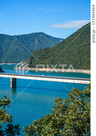 Scenic side view of a bridge crossing Piva Lake in Montenegro, surrounded by high mountains and natural landscape Scenic side view of a bridge crossing Piva Lake in Montenegro, surrounded by high mountains and natural landscape 131464864