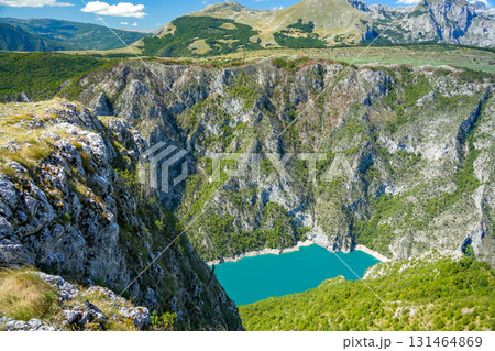 Scenic view of a mountain canyon in Montenegro, featuring rugged cliffs and dense forest, ideal for travel, nature, and outdoor projects Scenic view of a mountain canyon in Montenegro, featuring rugged cliffs and dense forest, ideal for travel, nature, and outdoor projects 131464869