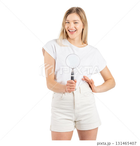 Studio portrait of woman with magnifying glass 131465407