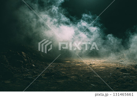 The surface of the earth with small stones and sand is covered with white fog in the darkness. 131465661