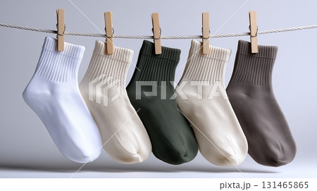 Colorful cotton socks hanging on a clothesline in a simple setup Colorful cotton socks hanging on a clothesline in a simple setup 131465865