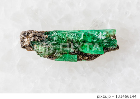 sample of unworked emerald crystal on white 131466144