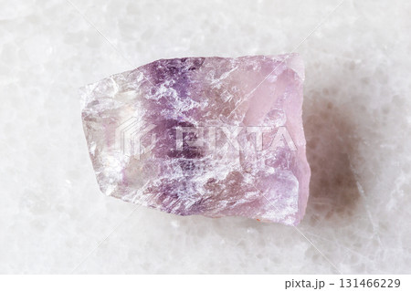unworked purple striped fluorite mineral on white 131466229