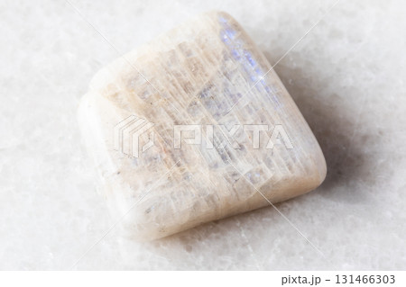polished belomorite moonstone rock on white marble 131466303
