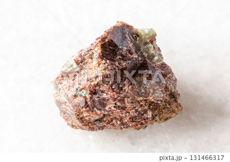 sample of rough eudialyte mineral on white marble 131466317