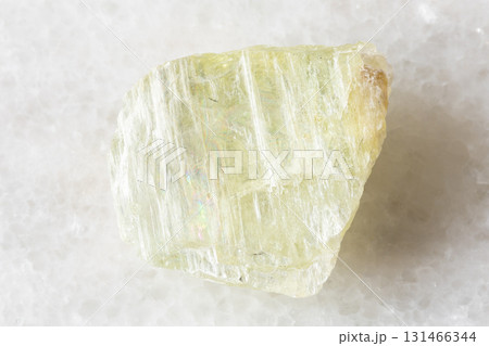 sample of rough hiddenite mineral on white marble sample of rough hiddenite mineral on white marble 131466344