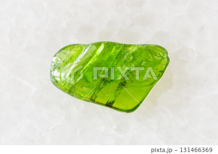 tumbled chromian diopside mineral on white marble 131466369